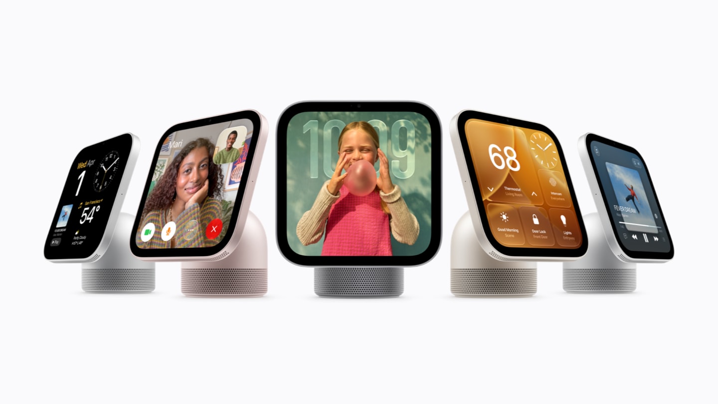 Five tabletop Apple HomeView displays in a row showing a clock, a FaceTime call, a photo, home controls and music